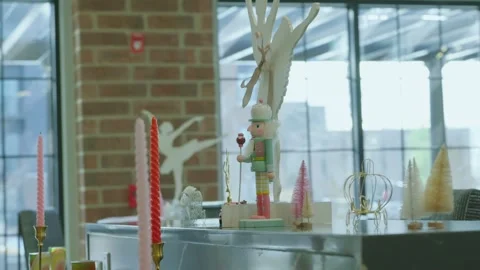 Pastel Nutcracker and Whimsical Holiday Display Against a Brick and Glass Video stock 303063544
