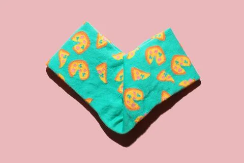 Pastel patterned colourful socks folded in heart shape on pink background. .. Stock Photos
