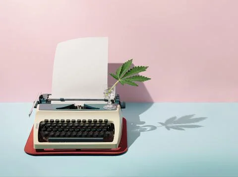 Pastel pink and blue background against retro vintage typing machine, paper a Stock Photos