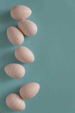 Pastel Pink Easter Eggs on Blue Background. Minimal Festive Composition Stock Photos
