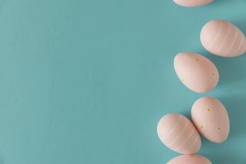 Pastel Pink Easter Eggs on Blue Background. Minimal Festive Composition Stock Photos