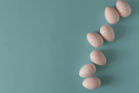 Pastel Pink Easter Eggs on Blue Background. Minimal Festive Composition Stock Photos