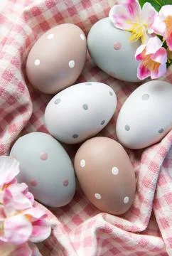 Pastel polka dot easter eggs in checkered basket Stock Photos