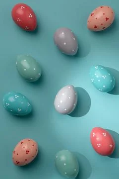 Pastel polka dot Easter eggs on turquoise background, partly sunlit with cris 写真素材