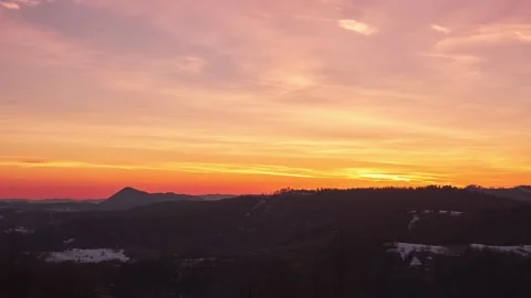 Pastel sky with slow moving clouds at dusk over forest landscape in spring. Stock Footage 174170904