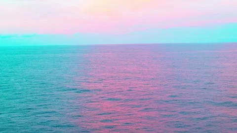 Pastel sunset reflection over calm ocean water horizon copy space Video stock 337587485