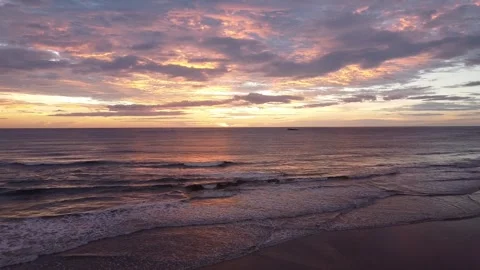 Pastel Sunset Sky Reflected on Wet Beach Sand and Ocean Waves Stock-Footage 320655880
