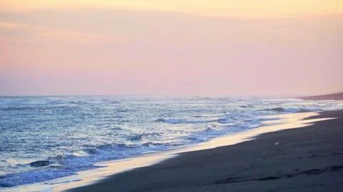 Pastel Sunset Waves Along Sandy Shore Stock Footage 337526872