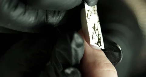 Pasting a sticker with a pattern on a nail in a beauty salon. Stock Footage 234196973