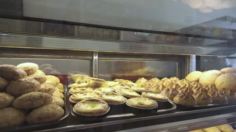 Pastries and biscuits arranged on a tray are available for sale. Stockbeeldmateriaal 285515218