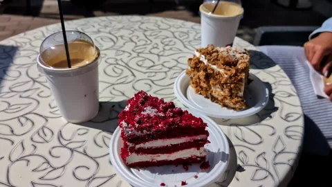 Pastries and coffee are served on a patio table, ready to enjoy. Stock Footage 277202916