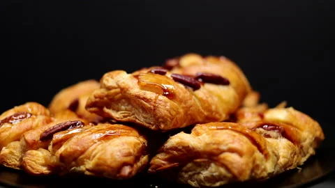Pastries With Roasted Pecan And Maple Syrup Spinning On The Black Plate On The B Stock Footage 149875202