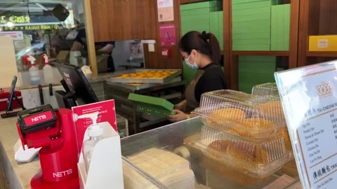 Pastry Assistant taking Eggtarts Stock Footage 168119381