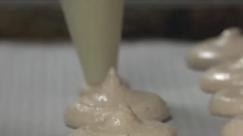 Pastry Bag Adding Macrons To Baking Sheet Stock Footage 136342689