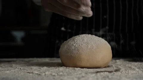 Pastry bakery chef applying and sprinkles flour over bread dough. Stock Footage 152383833