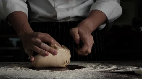 Pastry Bakery chef kneeding dough on wooden table. Stock Footage 150484669