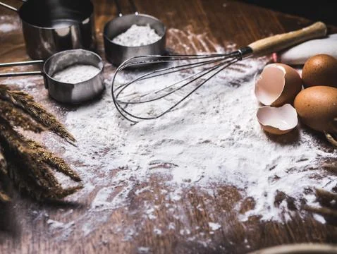Pastry Baking Accessories Bakery Background with flour and whisk. Ingredients Fotos Stock