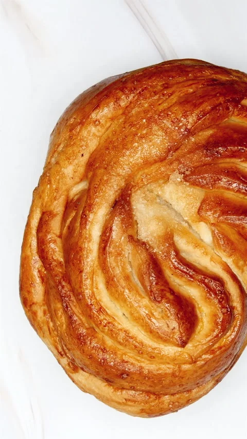 Pastry Bun Rotating On Marble Background. Top View. Vertical. Stock-Footage 267875017