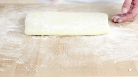 Pastry for buttermilk biscuits being rolled out and circles being cut out Stock Footage 24673073