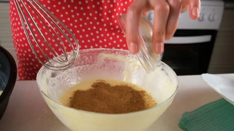 Pastry chef adding cocoa powder and mixing dough in glass bowl. Stock Footage 311529712
