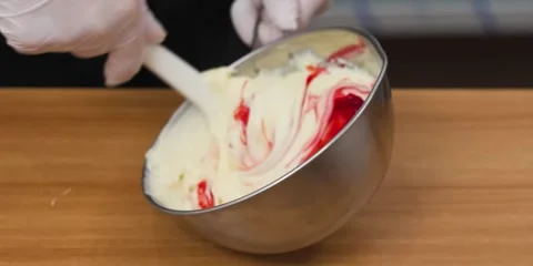 Pastry Chef Adding Red Gel Food Coloring to Creamy Buttercream Frosting in Metal Видео 343588534