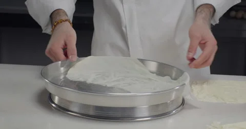 Pastry chef arrange phyllo dough sheets on a tray. Turkish dessert baklava Stock Footage 281516957