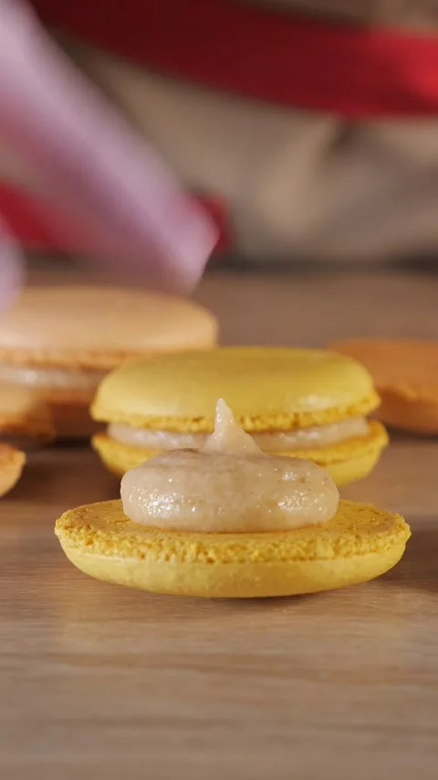Pastry chef assembling french macarons with cream filling Stock Footage 341443554