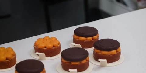 Pastry Chef Assembling Miniature Chocolate and Orange Cakes 스톡 동영상 343588840