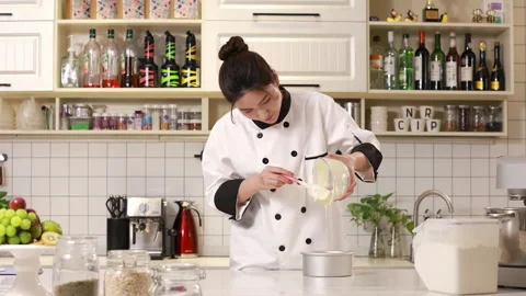Pastry chef baker pouring dough or cake batter into metal ring molds for baking Stock Footage 339206468
