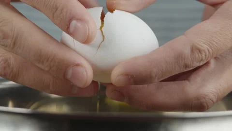 Pastry chef breaks eggs into dishes to beat them with sugar to make a biscuit Stock Footage 286306568