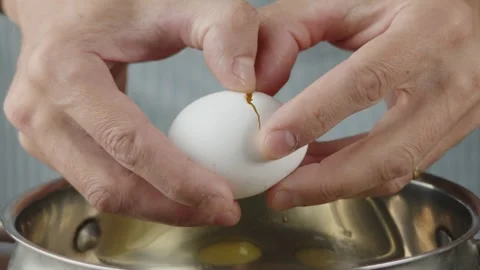 Pastry chef breaks eggs into dishes to beat them with sugar to make a biscuit Stock Footage 286306619