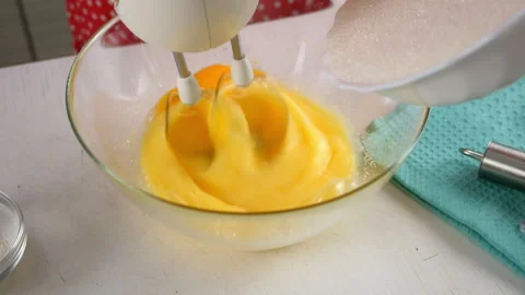 Pastry chef combining whipped egg with sugar mixing in glass bowl. Stock Footage 311527183