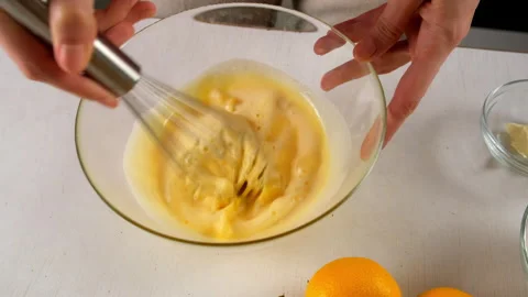 Pastry chef cooking adding sugar to bowl with eggs and creamy orange zest. Stock Footage 317233519