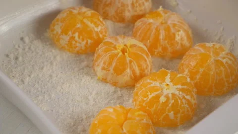 Pastry chef cooking pie placing peeled mandarin orange halves in baking dish. Stock Footage 317231696