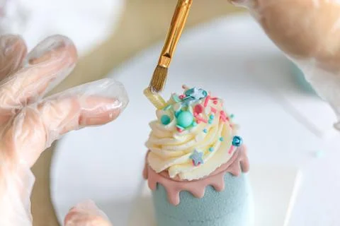 The pastry chef decorates the cake. Assorted mini cakes sweet dessert Фото