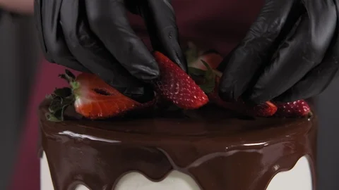 Pastry chef decorates cake with berries. Chef confectioner decorates cake Stock Footage 106297975