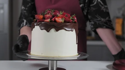Pastry chef decorates cake with berries. Chef confectioner decorates cake Stock Footage 106298432