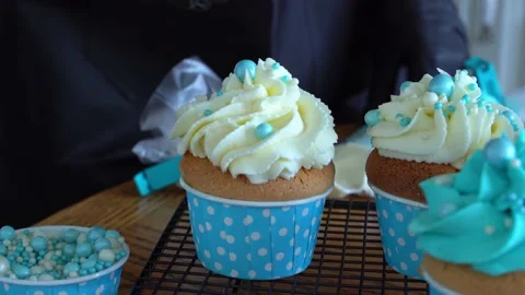 The pastry chef decorates the cupcake with confectionery balls . Decorating Stock Footage 170193100