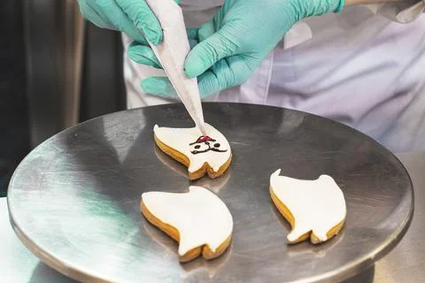 The pastry chef decorates the dessert using a pastry bag. A master class. Close Stock Photos