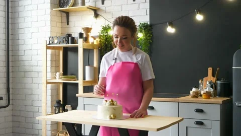 Pastry chef is decorating beautiful cake in the kitchen indoors Stock Footage 152953122