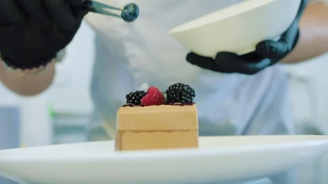 Pastry chef decorating with berries pie pastry Stock Footage 112948242