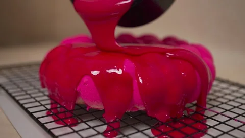 Pastry chef decorating cake with mirror pink glaze Stock Footage 264031351