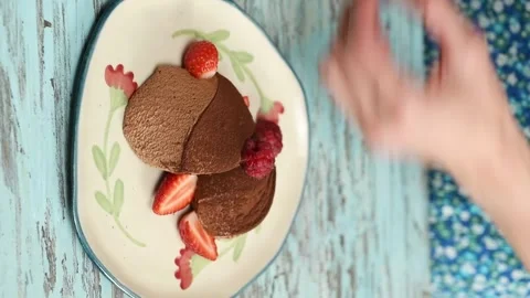 The pastry chef decorating chocolate mousse with strawberries. Vertical video. Stock Footage 305154634