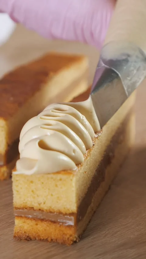 Pastry chef decorating layered sponge cake with cream Stock-Footage 341441656