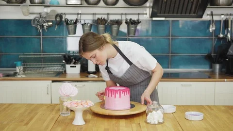 Pastry chef decorating pink drip cake Stock Footage 108877167