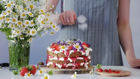 Pastry chef is decorating top of the multilayered cake with powdered sugar. Stock Footage 102932066