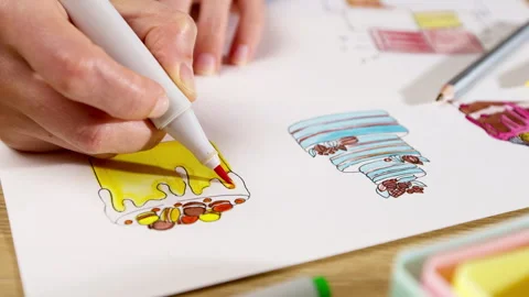 The pastry chef develops a cake design by drawing on paper.  Stock Footage 253318644