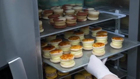 Pastry Chef Extracting Freshly Baked Crème Brûlée Fatcarons from Commercial Oven Stock Footage 343019844