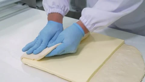 Pastry Chef Folding Raw Puff Pastry Dough with Butter Sheet for Lamination in Pr Stock Footage 337751366