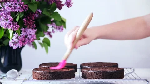 Pastry chef is greasing cake layer with confectionery spatula. Stock Footage 102042561